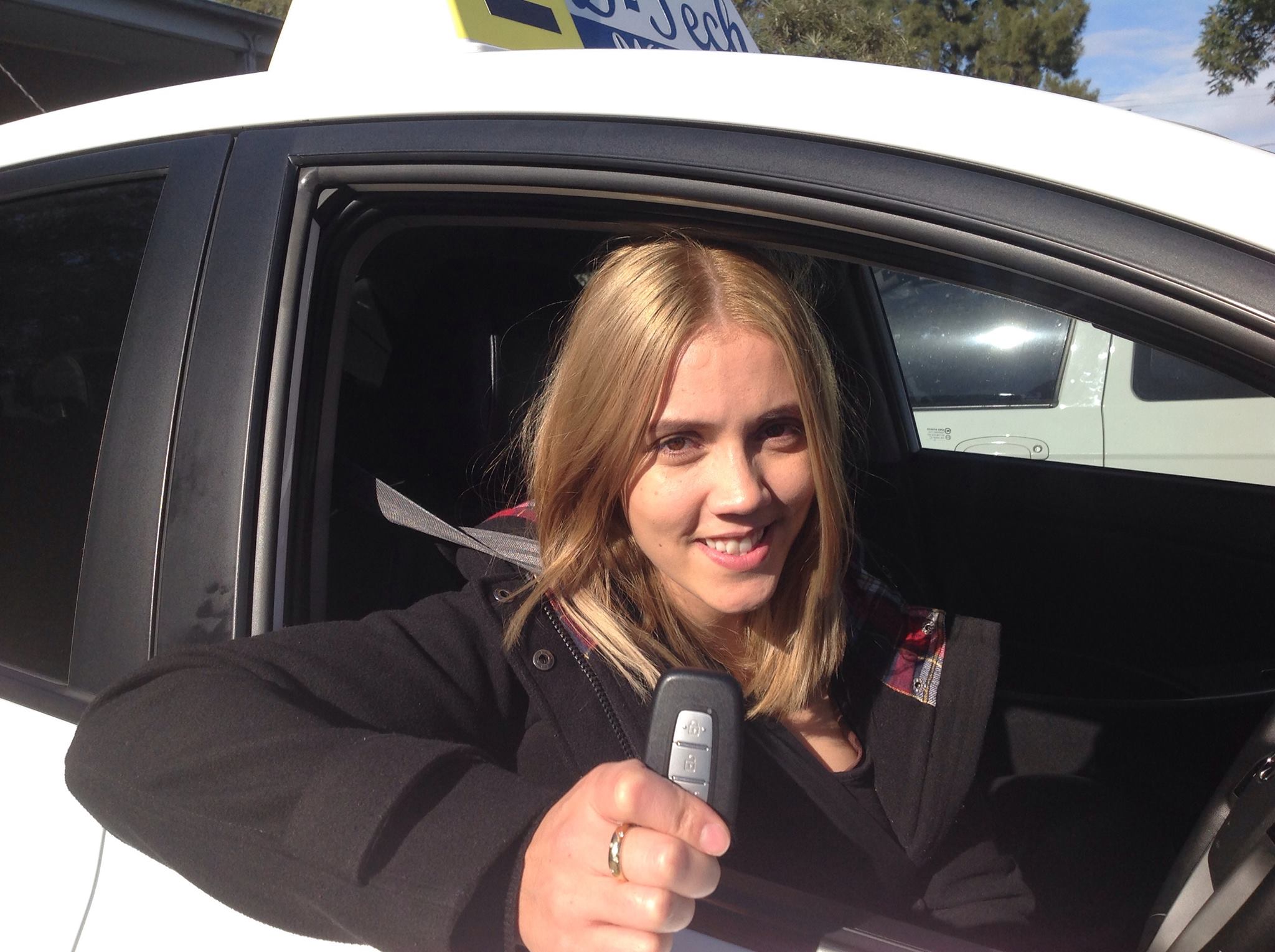 Successful D-Tech driving student celebrating passing their practical test at Castle Hill Registry.