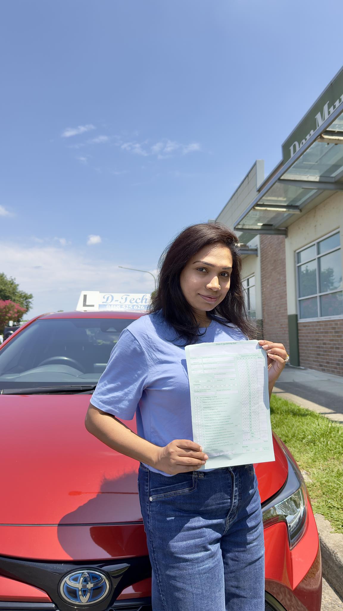 Successful D-Tech driver training student celebrating passing their practical driving test at Penrith Service NSW registry 1.