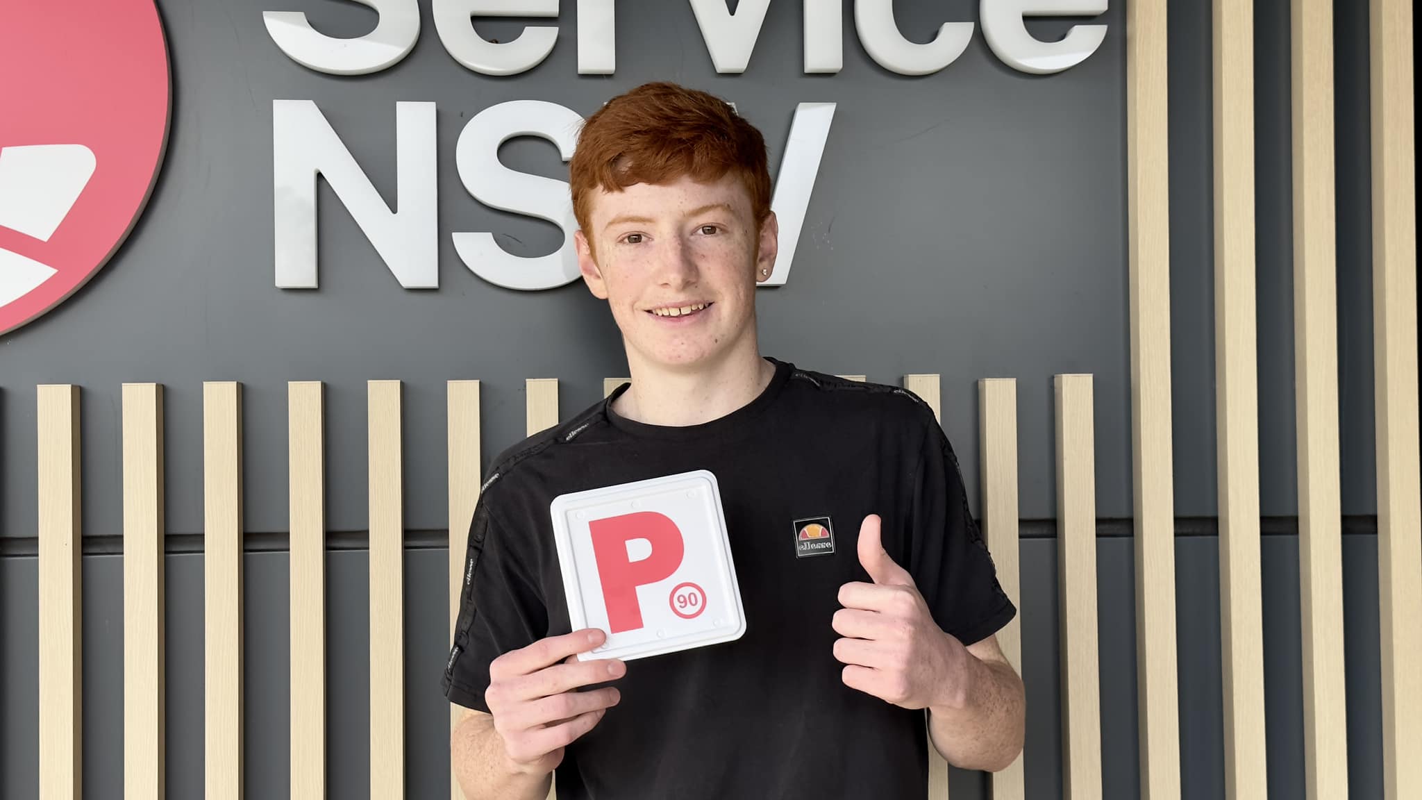 Successful D-Tech driving student celebrating practical test pass at Richmond Service NSW near South Windsor.