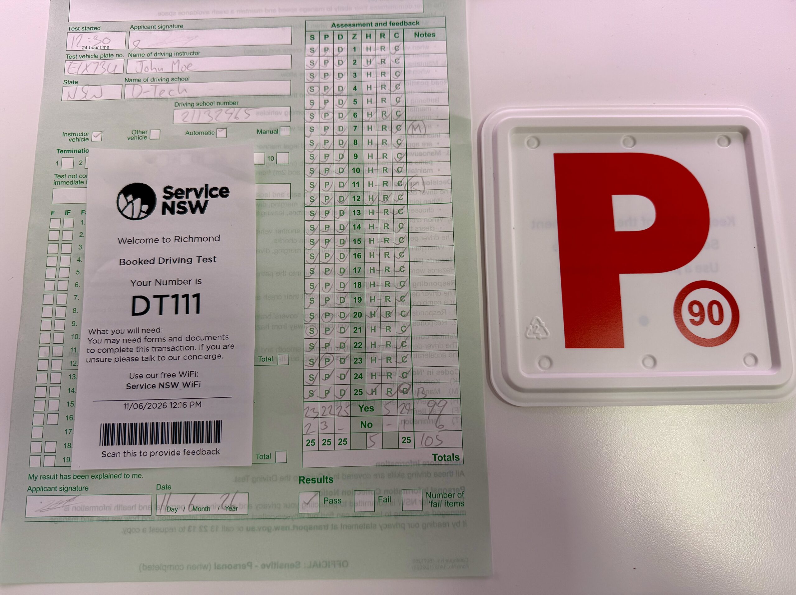 Service NSW driving test score sheet, ticket, and a Red P-plate indicating first-time driving test success.