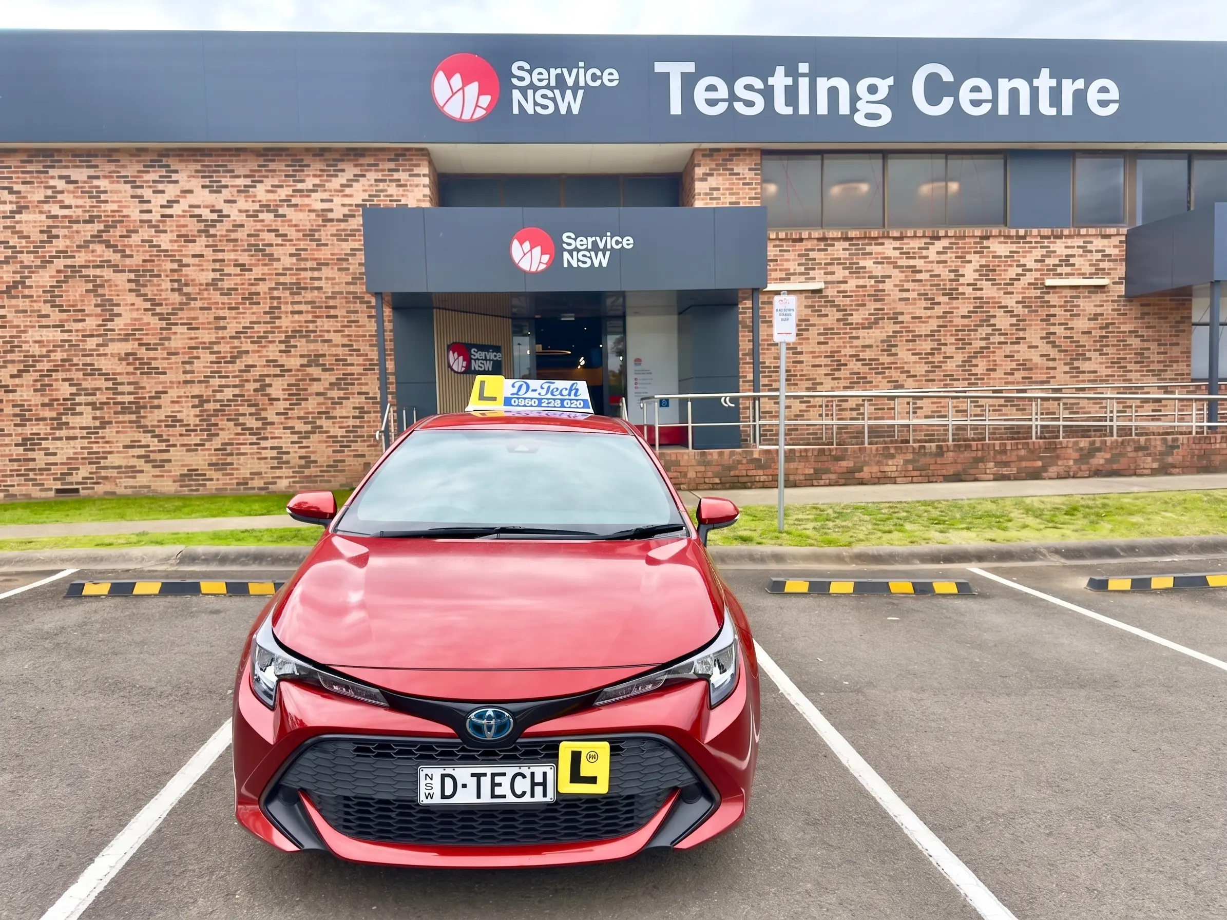 D-Tech Driver Training dual-control car parked in front of St Marys Service NSW Testing Centre.